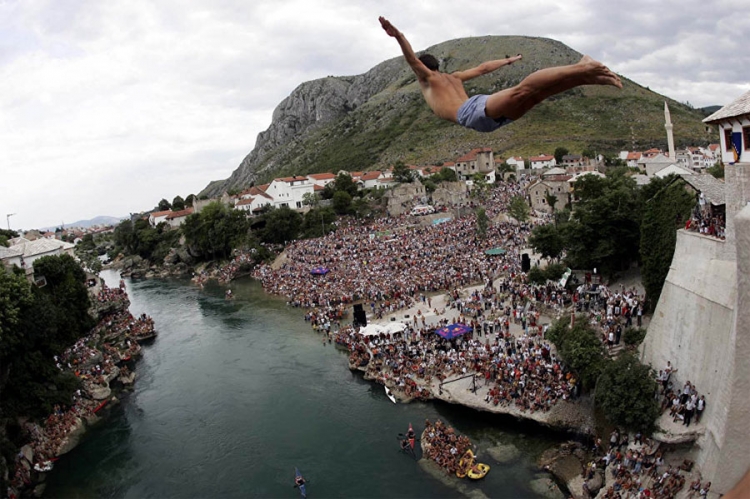 Mladić skače sa rekonstruisanog, 22 metra visokog Starog mosta na Neretvi tokom tradicionalnog takmičenja. 


