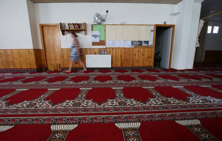 A woman walks at a mosque where imam Abdelbaki Es Satty preached in Ripoll, nort